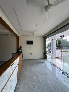 a person standing in a room with a lobby at Hotel Embassy Inn in Ānakhol