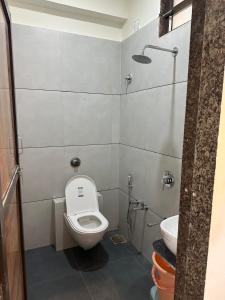 a small bathroom with a toilet and a sink at Hotel Embassy Inn in Ānakhol +12 photos