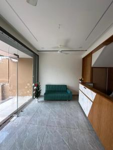 a living room with a green couch in a room at Hotel Embassy Inn in Ānakhol