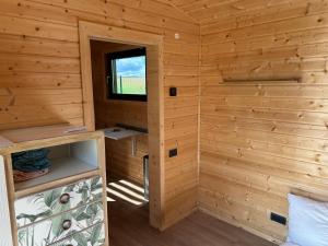 a cabin with a small window in a wooden wall at La Tiny du Clos Ernest in Cheminot