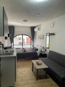 a living room with a couch and a bed at Helios in Ioannina