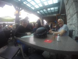 a man and woman sitting at a table in a restaurant at RUBY LODGINg in Banilad