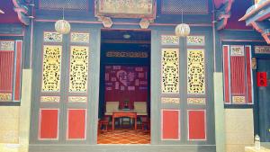 an entrance to a building with red and yellow doors at 隆馨大悅古厝旅宿 in Jinhu