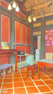 a room with a table and benches in a room at 隆馨大悅古厝旅宿 in Jinhu