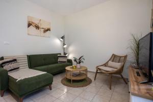 a living room with a green couch and a chair at Iriada House in Rhodes Town +49 photos