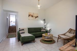 a living room with a green couch and chairs at Iriada House in Rhodes Town