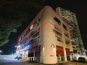 a building with a red stripe on the side of it at Wayton Cottage in George Town