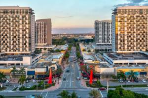 a city with tall buildings and a street with cars at Modern Studio Pool View Downtown Doral' Heart in Miami