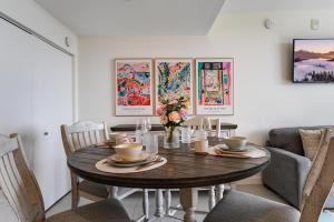 a dining room with a wooden table and chairs at Modern Studio Pool View Downtown Doral' Heart in Miami