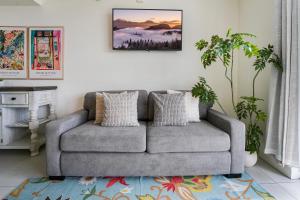 a living room with a gray couch and a table at Modern Studio Pool View Downtown Doral' Heart in Miami
