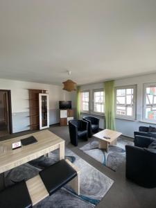 a living room with couches and a table at Pension Zum Angestellten in Porta Westfalica