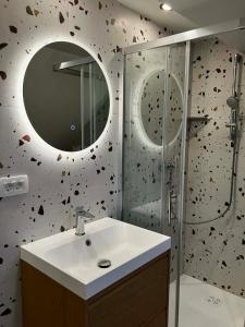 a bathroom with a sink and a shower with a mirror at Apartments Lajk in Lesce +70 photos