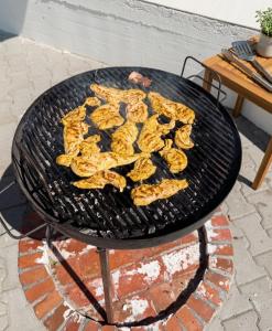 a bunch of food is cooking on a grill at Panorama Pool Hills in Ledinci