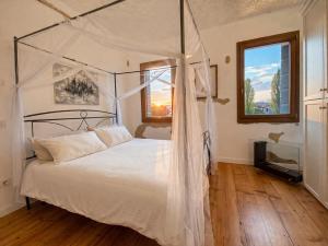 a bedroom with a white bed with a canopy at Villa Venezia Apartment in Dolo