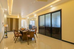 a dining room with a table and chairs at Kamdhenu - Luxurious stay in Udaipur