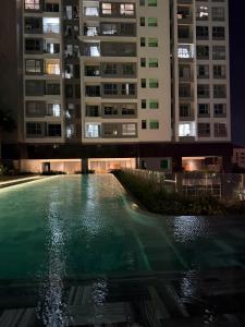 a swimming pool in front of a building at night at 221B Baker in Ga Phú Văn