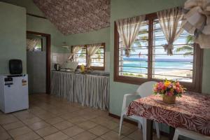 a kitchen with a table with flowers on it at Leimalo's Bungalow in Port Vila