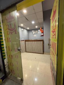 an open door to a waiting room in a restaurant at Bloom Hotel in Jagādhri