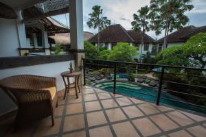 a balcony with a view of a swimming pool at Ecosfera Hotel & Spa in Canggu