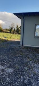 a white building with a window on the side of it at Cozy Double Ensuite Room in Ennistymon