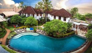 an aerial view of a swimming pool in front of a house at Ecosfera Hotel & Spa in Canggu