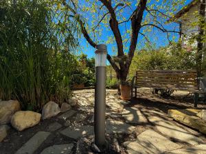 a street light in front of a park bench at Fortuna Garden House in Imperia