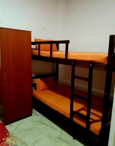a room with two bunk beds and a cabinet at Thambili lk in Colombo