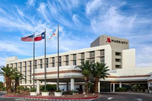 a hotel with two flags in front of a building at Marriott El Paso in El Paso