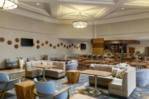 a lobby with couches and tables and a restaurant at Marriott El Paso in El Paso