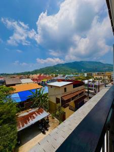 a view of a city from a balcony at Mersey Residence Koh Samui in Lamai