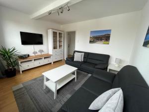 a living room with a couch and a tv at Fewo Haus Piepenbreier in Bad Sassendorf