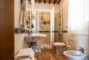 a bathroom with a sink and a toilet at Hotel La Fonte Del Cerro in Saturnia +113 photos