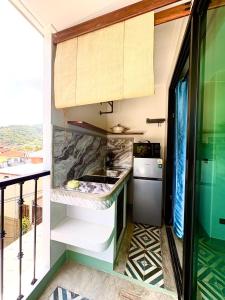 a kitchen with a sink and a counter at Mersey Residence Koh Samui in Lamai