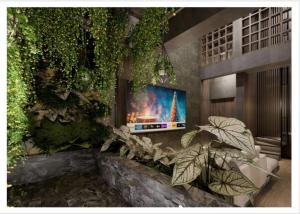 a living room with a tv and a fireplace at The Foresta By Ohana in Timuran