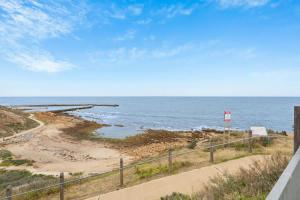a path to the beach with the ocean in the background at Sunset Ocean View Retreat 4BM House in Christies Beach +32 photos
