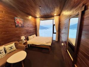 a small room with a bed and a couch at Trúc house in Kon Rung (1)
