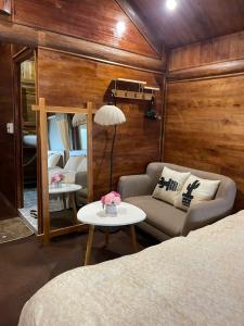 a room with a bed and a couch and a table at Trúc house in Kon Rung (1)