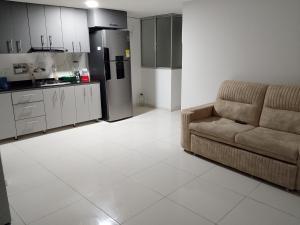 a living room with a couch and a kitchen at Edificio Karu in Pamplona