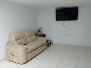 a living room with a chair and a tv at Edificio Karu in Pamplona