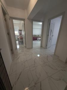 a large hallway with marble flooring in a house at Anastasia in Mangalia