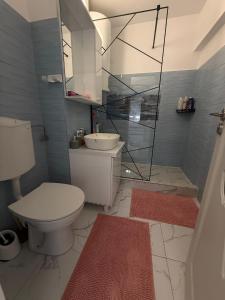 a bathroom with a toilet and a sink and a mirror at Anastasia in Mangalia