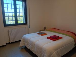 a bedroom with a bed with two towels on it at Casa Don Peppì in Monopoli