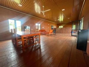 a dining room with tables and chairs in a building at Dico Surf Point- Surf Lodge in Simeulue in Lasikin