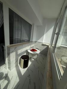 a balcony with a small table and a stool at Anastasia in Mangalia