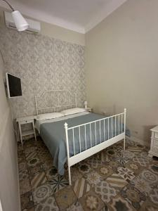 a bedroom with a bed and a tv on a wall at Il giardino segreto in Taranto