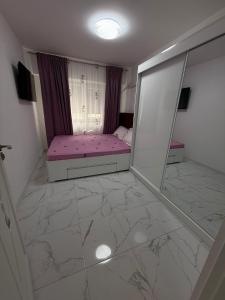 a bedroom with a pink bed and a mirror at Anastasia in Mangalia