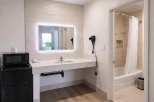 a bathroom with a sink and a shower at Motel Moonlight in Anaheim