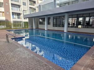 a large swimming pool in front of a building at Studio near JKIA and SGR Syokimau in Nairobi