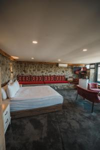 a bedroom with a bed and a couch and a chair at Montana Resort Otel in Trabzon