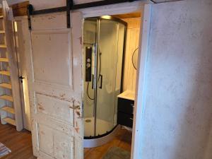 a shower with a glass door in a room at Norra Vilan - Hagalund in Kopparberg
